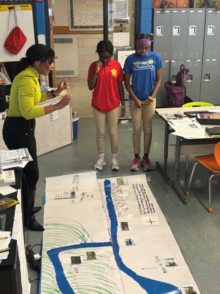 Educator facilitating multimodal, language-rich instruction with elementary students during professional learning session.